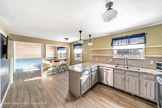 an empty room with wooden floor and ceiling fan