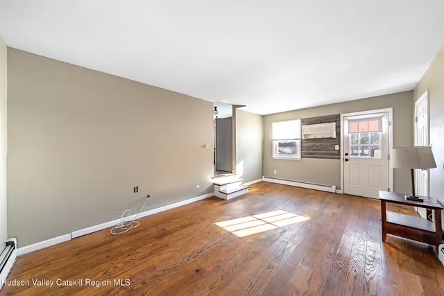 a spacious bedroom with a bed and a chandelier