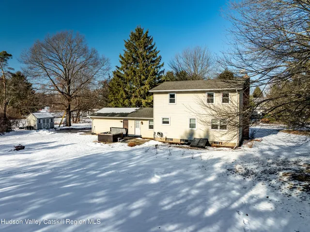 a view of a house with snow on the road