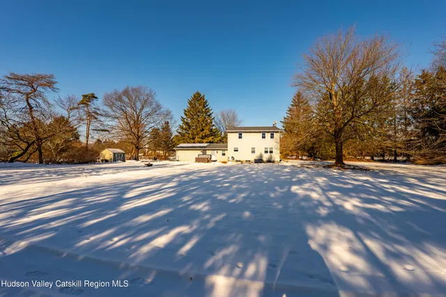 a view of house with backyard