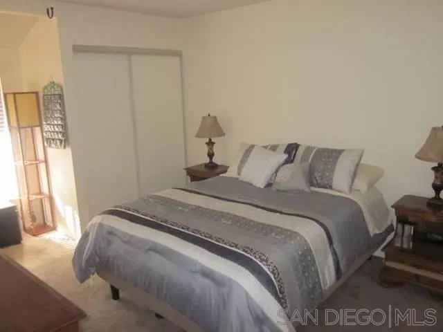 6876 Bear River Row, Unit 3 San Diego, CA 92139 - Photo 3 of 7 a bedroom with a bed and a window