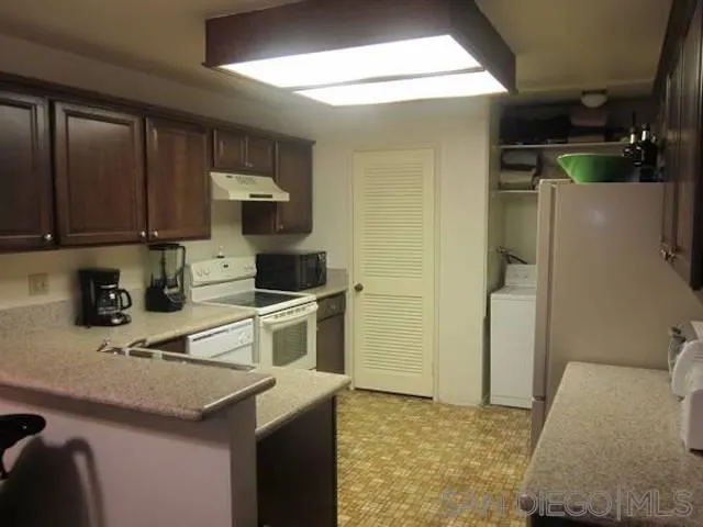 6876 Bear River Row, Unit 3 San Diego, CA 92139 - Photo 4 of 7 a kitchen with a sink cabinets and appliances