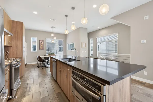a kitchen with a stove a sink and a refrigerator