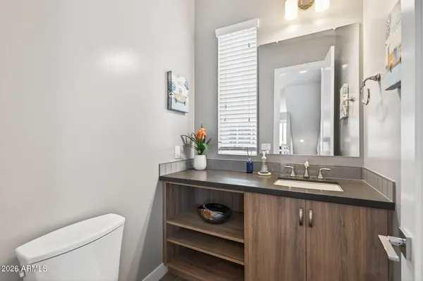a large kitchen with lots of counter space a sink appliances and living room view