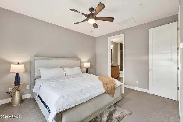 a bedroom with a bed and cabinets