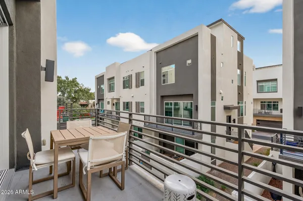a balcony view with a seating space