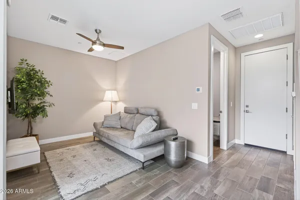 a living room with furniture and a potted plant