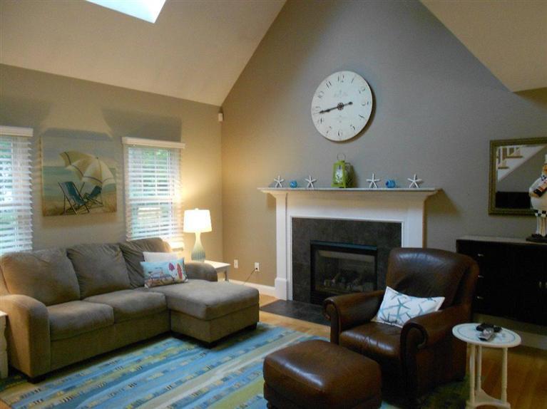 1171 Shootflying Hill Road Centerville, MA 02632 - Photo 1 of 16 a living room with furniture a fireplace and a large window