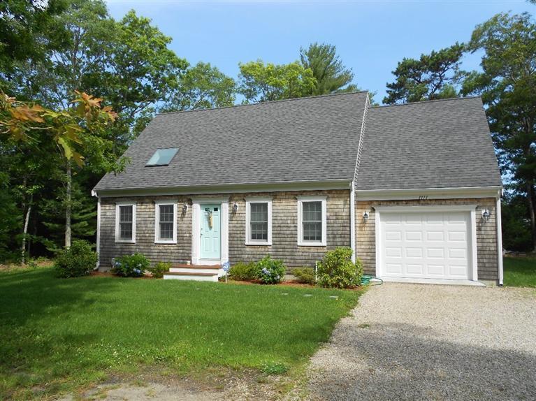 1171 Shootflying Hill Road Centerville, MA 02632 - Photo 12 of 16 a front view of a house with a garden and plants