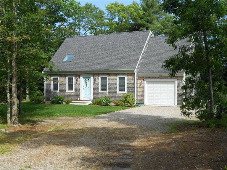 1171 Shootflying Hill Road Centerville, MA 02632 - Photo 13 of 16 a front view of a house with a yard and garage