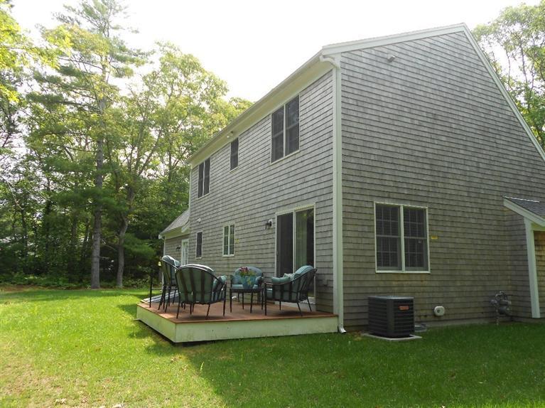 1171 Shootflying Hill Road Centerville, MA 02632 - Photo 14 of 16 a view of a house with backyard and sitting area