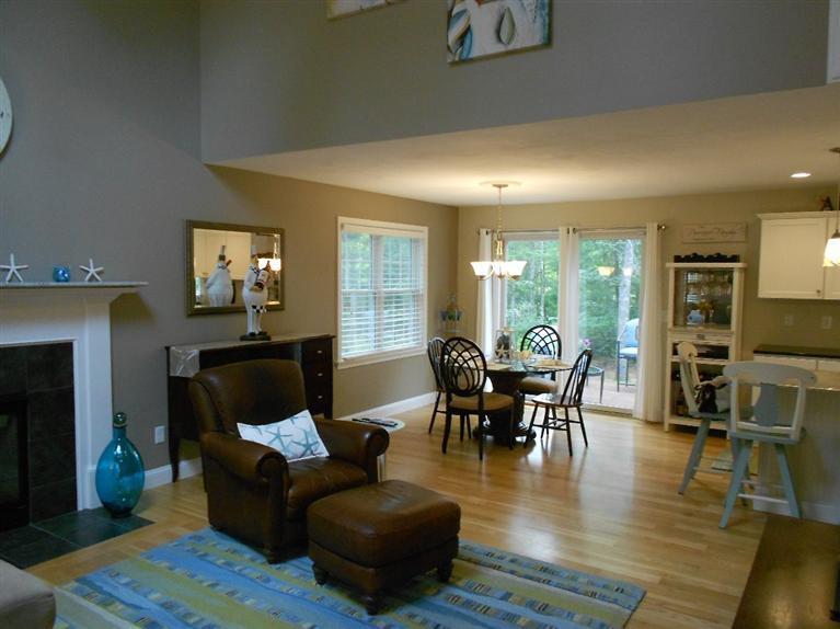 1171 Shootflying Hill Road Centerville, MA 02632 - Photo 2 of 16 a living room with furniture wooden floor and a fireplace
