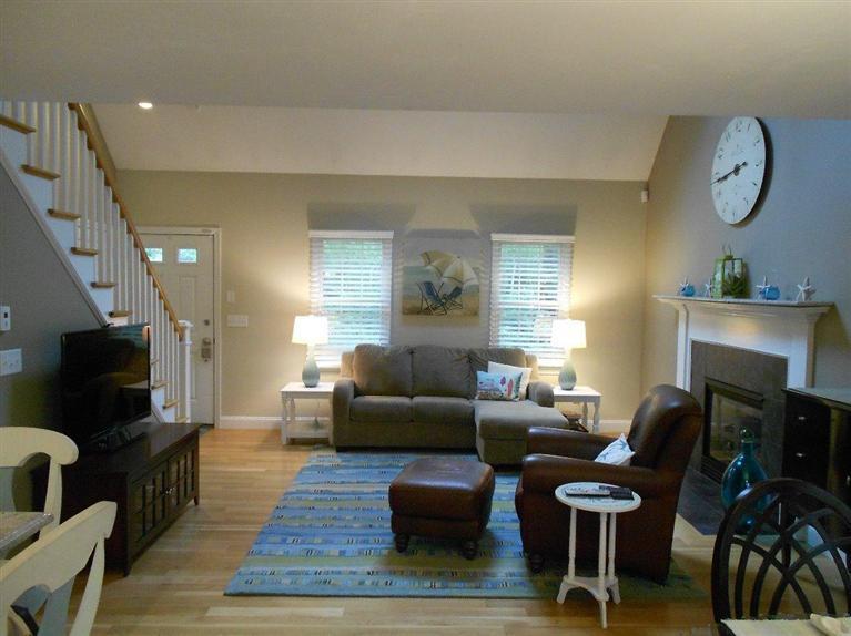 1171 Shootflying Hill Road Centerville, MA 02632 - Photo 5 of 16 a living room with furniture a flat screen tv and a fireplace