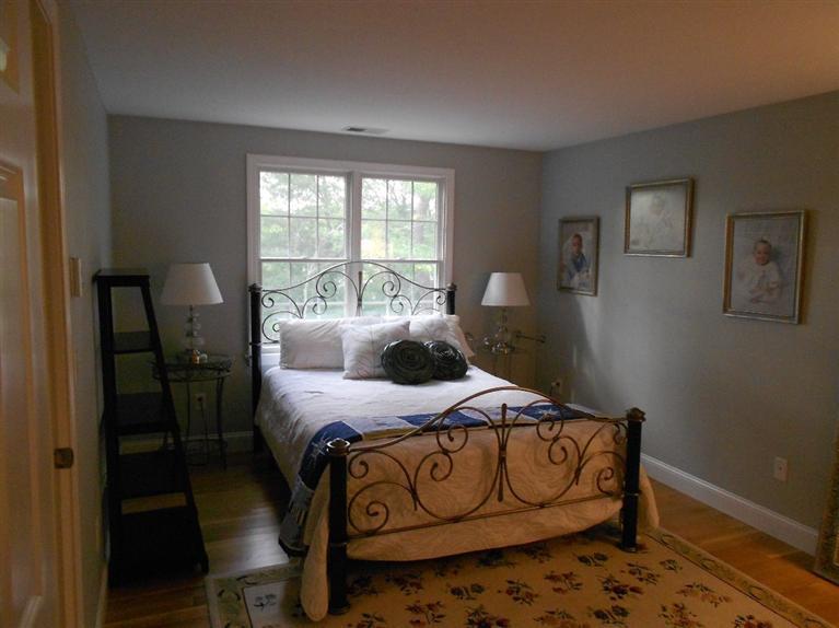 1171 Shootflying Hill Road Centerville, MA 02632 - Photo 9 of 16 a bedroom that has a bed and a table in it