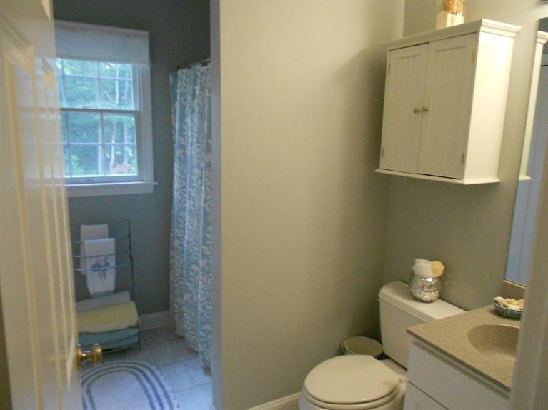 1171 Shootflying Hill Road Centerville, MA 02632 - Photo 10 of 16 a white toilet sitting next to a bathroom sink