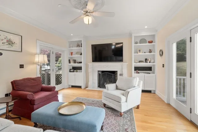 a living room with furniture a flat screen tv and a fireplace