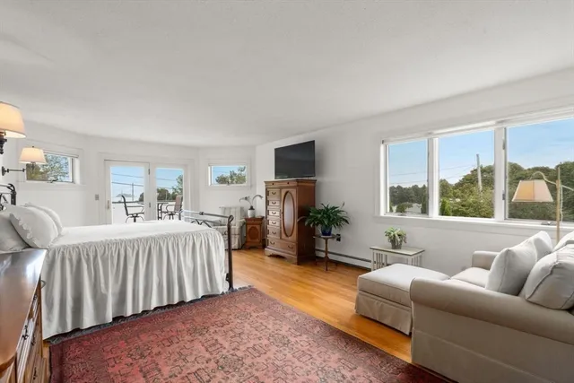 a bedroom with furniture and a large window