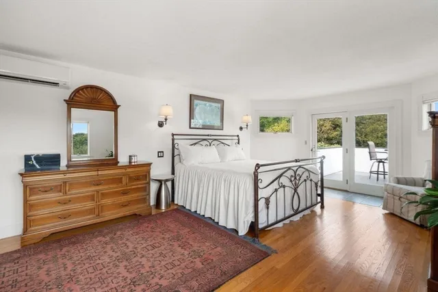 a bedroom with furniture and a wooden floor