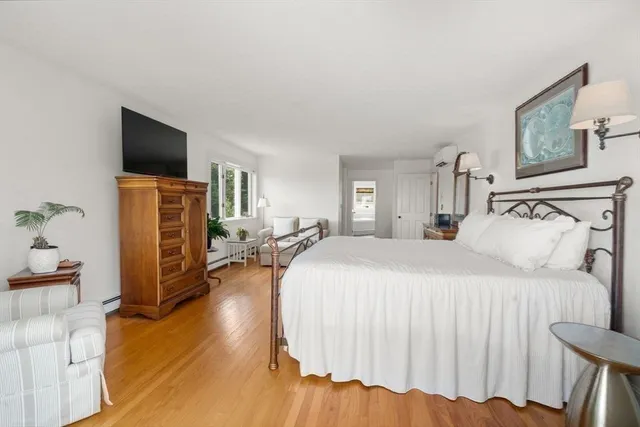 a bedroom with a bed and flat screen tv