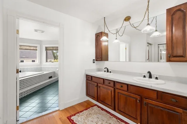 a bathroom with a double vanity sink and a mirror