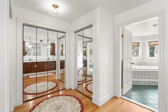 a view of a bathroom with tub and door