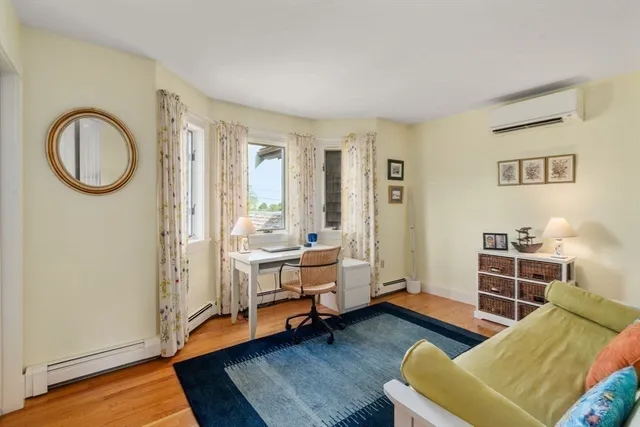 a bedroom with furniture and a wooden floor