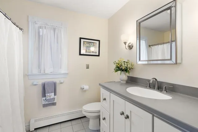 a bathroom with a granite countertop sink toilet and mirror