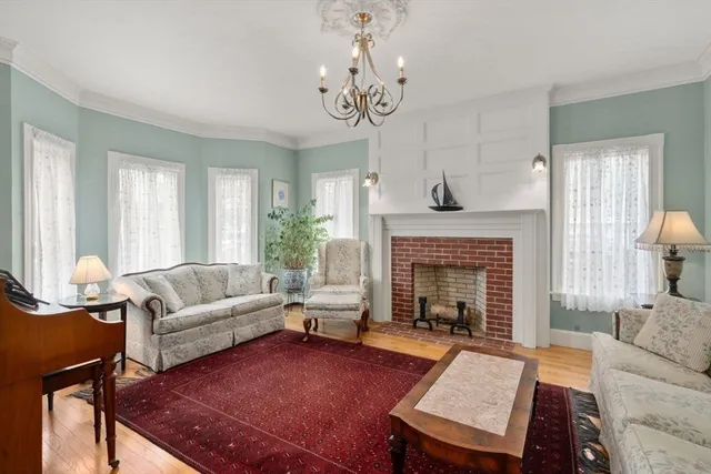 a living room with furniture a fireplace and window