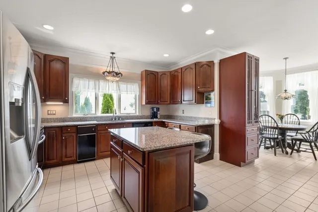 a kitchen with stainless steel appliances granite countertop sink stove top oven and refrigerator