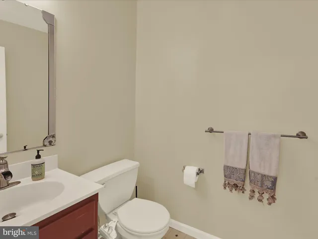 a bathroom with a sink a toilet and mirror