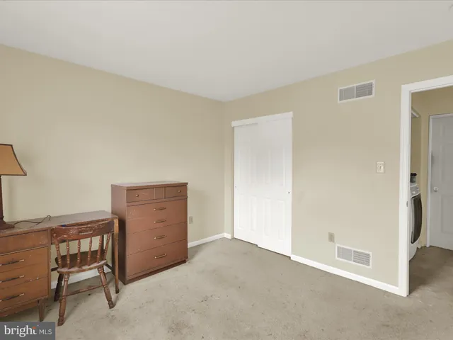 a room that has a dresser and a chair in it