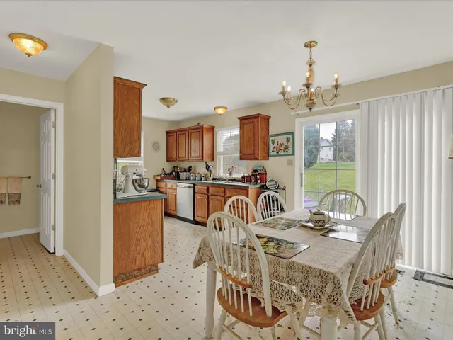 a view of a dining room with furniture a chandelier and wooden floor
