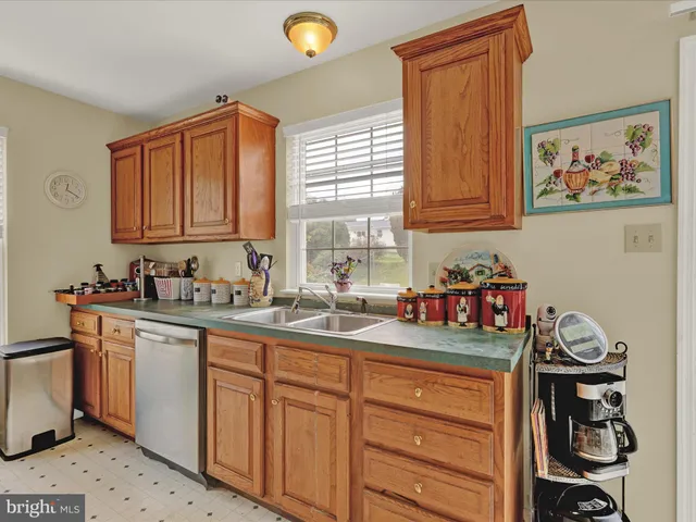 a kitchen with sink cabinets and window