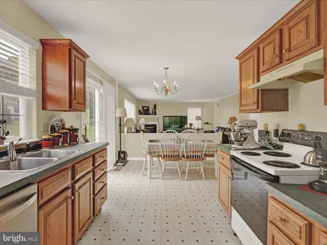 a kitchen with stainless steel appliances a sink stove and cabinets