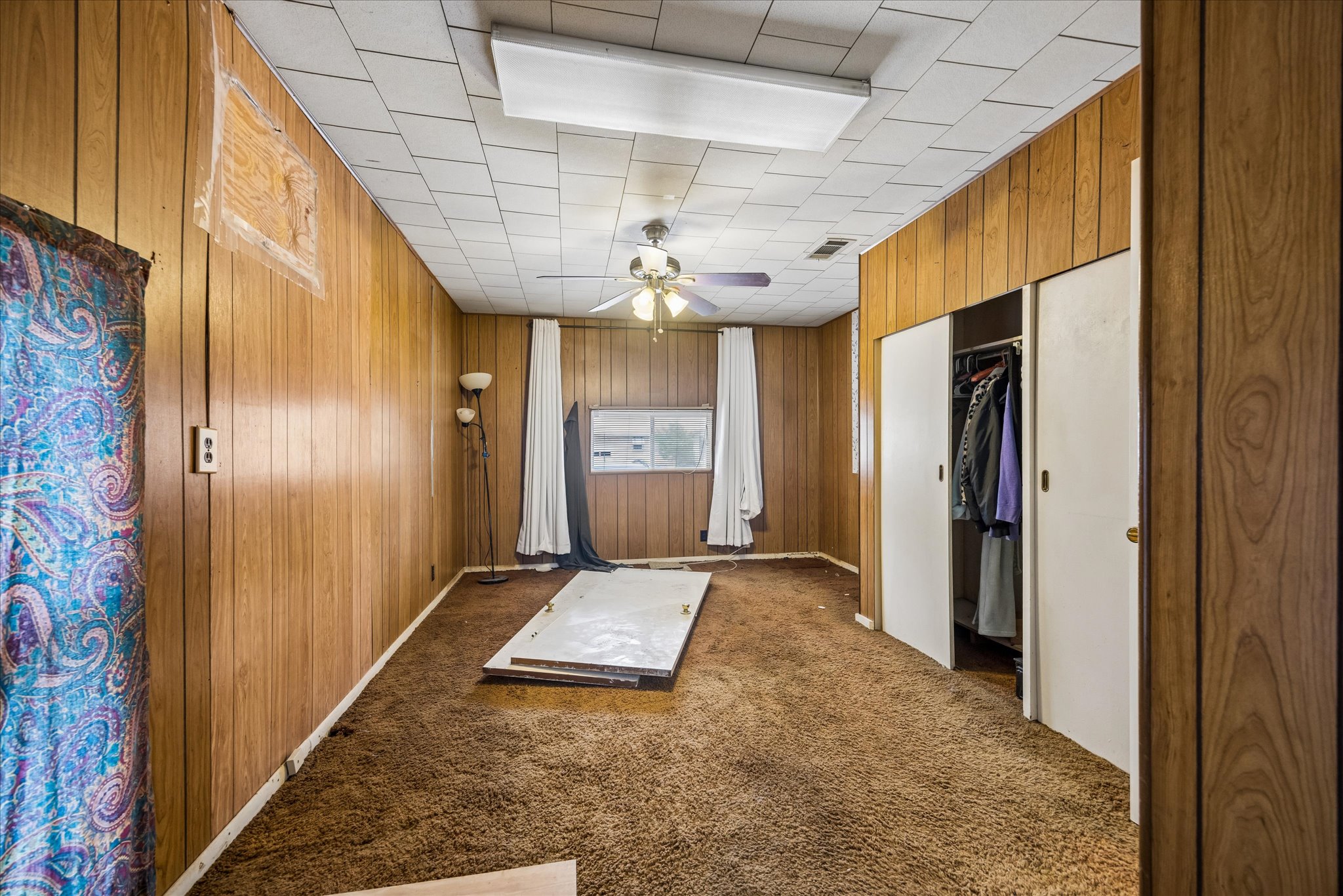 2009 Fort View Road Austin, TX 78704 - Photo 27 of 40 A versatile space ready for your personalized touch, featuring warm wood paneling and practical closet storage.