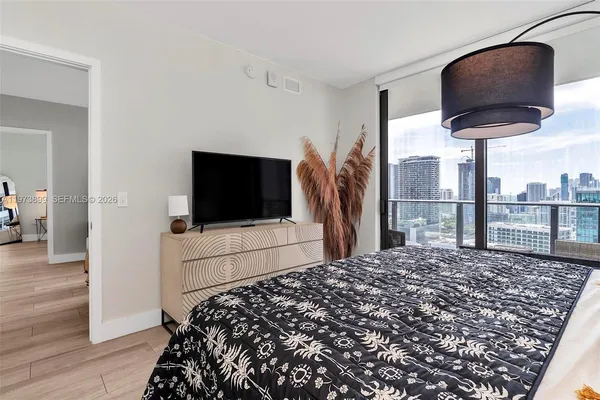 a bedroom with a bed and flat screen tv