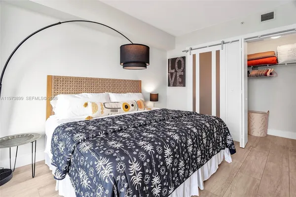 a bedroom with bed and window