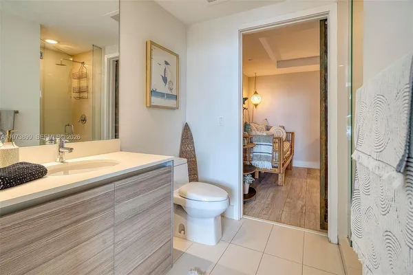 a bathroom with a sink toilet and a mirror