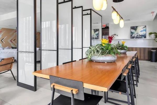 a room with furniture pool table gym equipment and a flat screen tv