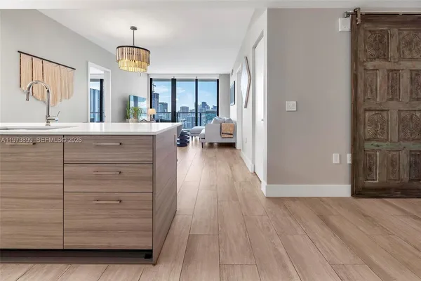 a view of living room with cabinets and wooden floor