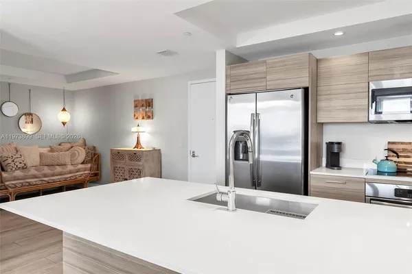 a kitchen with kitchen island sink refrigerator and stove