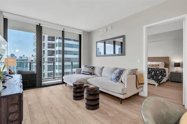 a living room with furniture and a large window