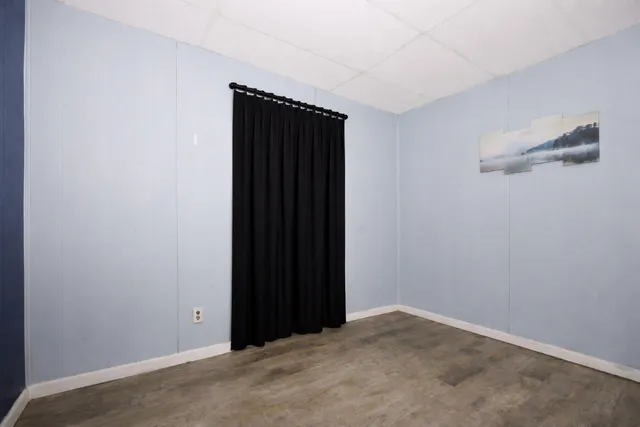 a bedroom with double bed and mirror