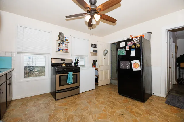 a kitchen with stainless steel appliances granite countertop a refrigerator and a stove