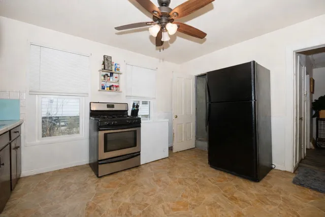 a kitchen with a stove top oven and cabinets