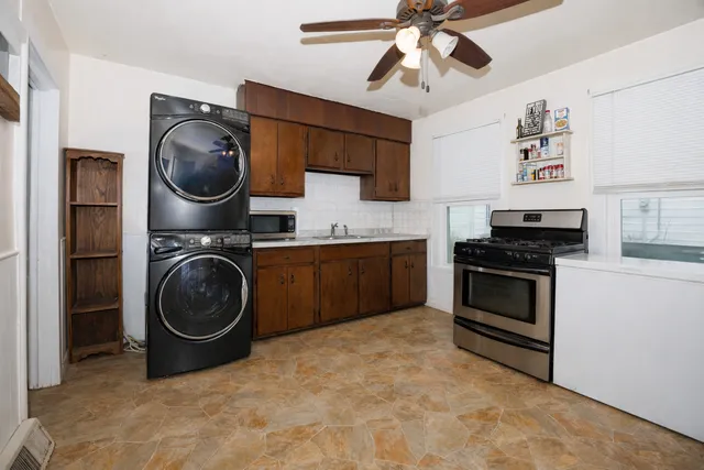 a kitchen with stainless steel appliances granite countertop a stove a refrigerator and a sink