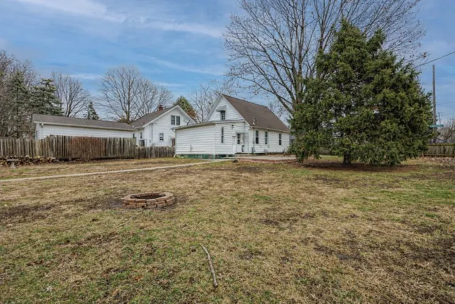 a view of a yard with plants and trees