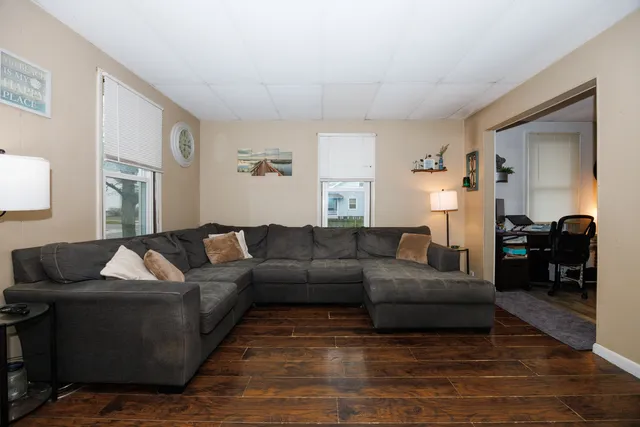 a living room with furniture and a wooden floor