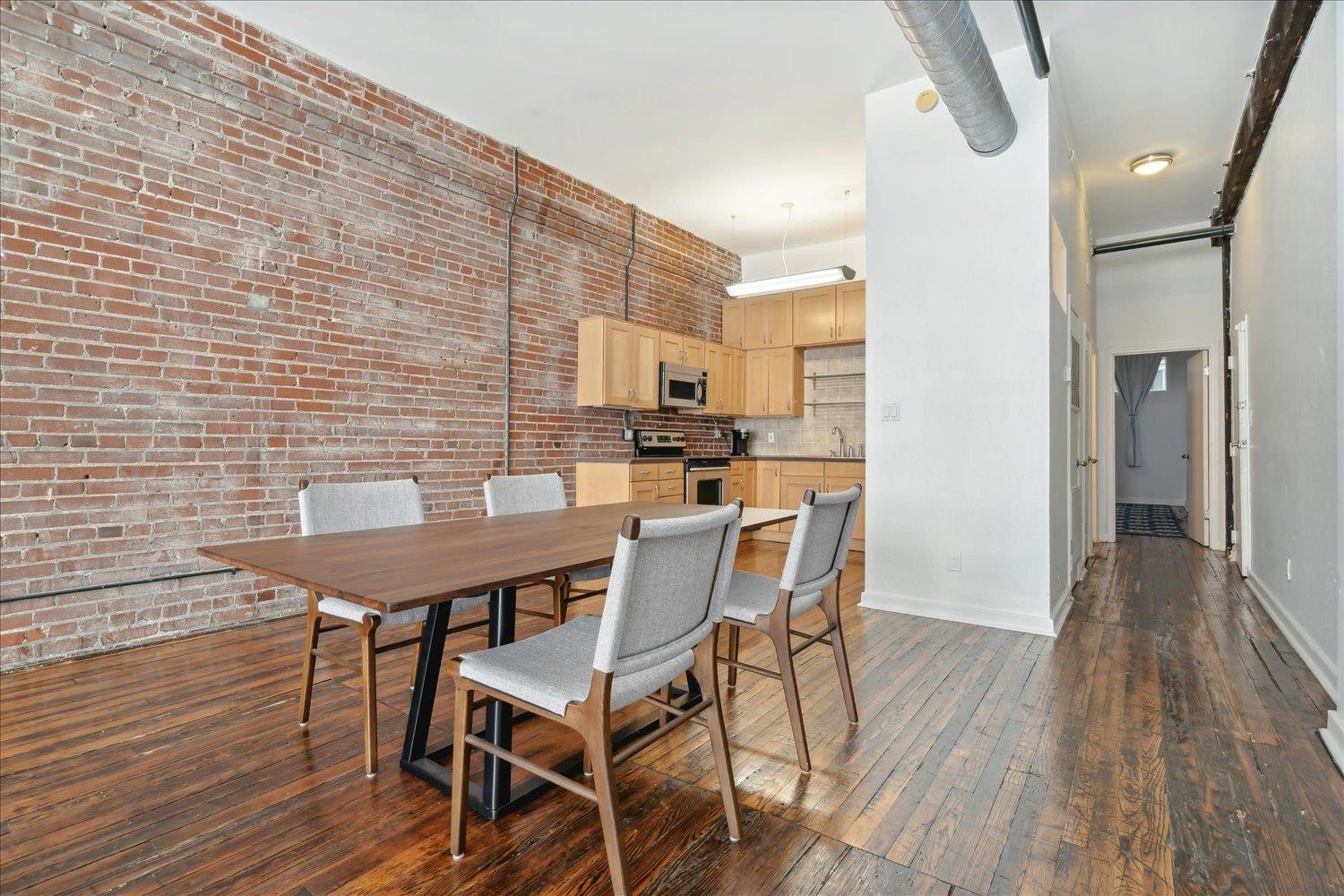 413 South Main Street, Unit 206 Memphis, TN 38103 - Photo 11 of 23 a view of a dining room with furniture and wooden floor