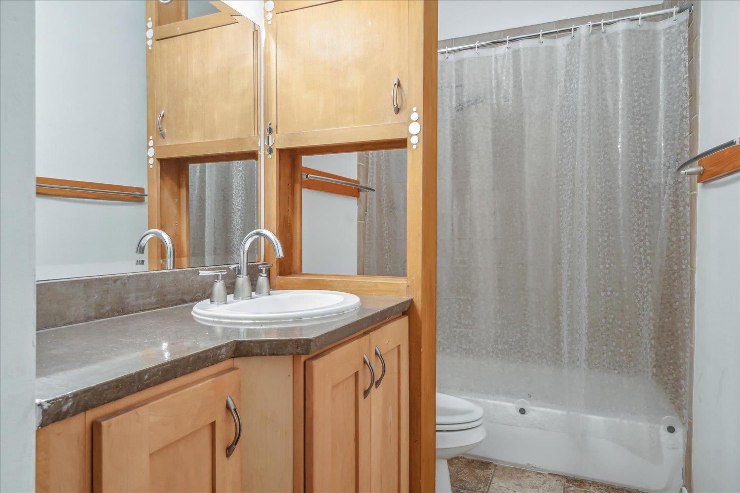 413 South Main Street, Unit 206 Memphis, TN 38103 - Photo 12 of 23 a bathroom with a granite countertop sink and a mirror